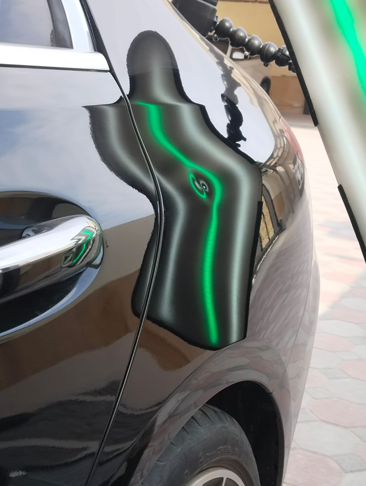 Technician working on a car panel